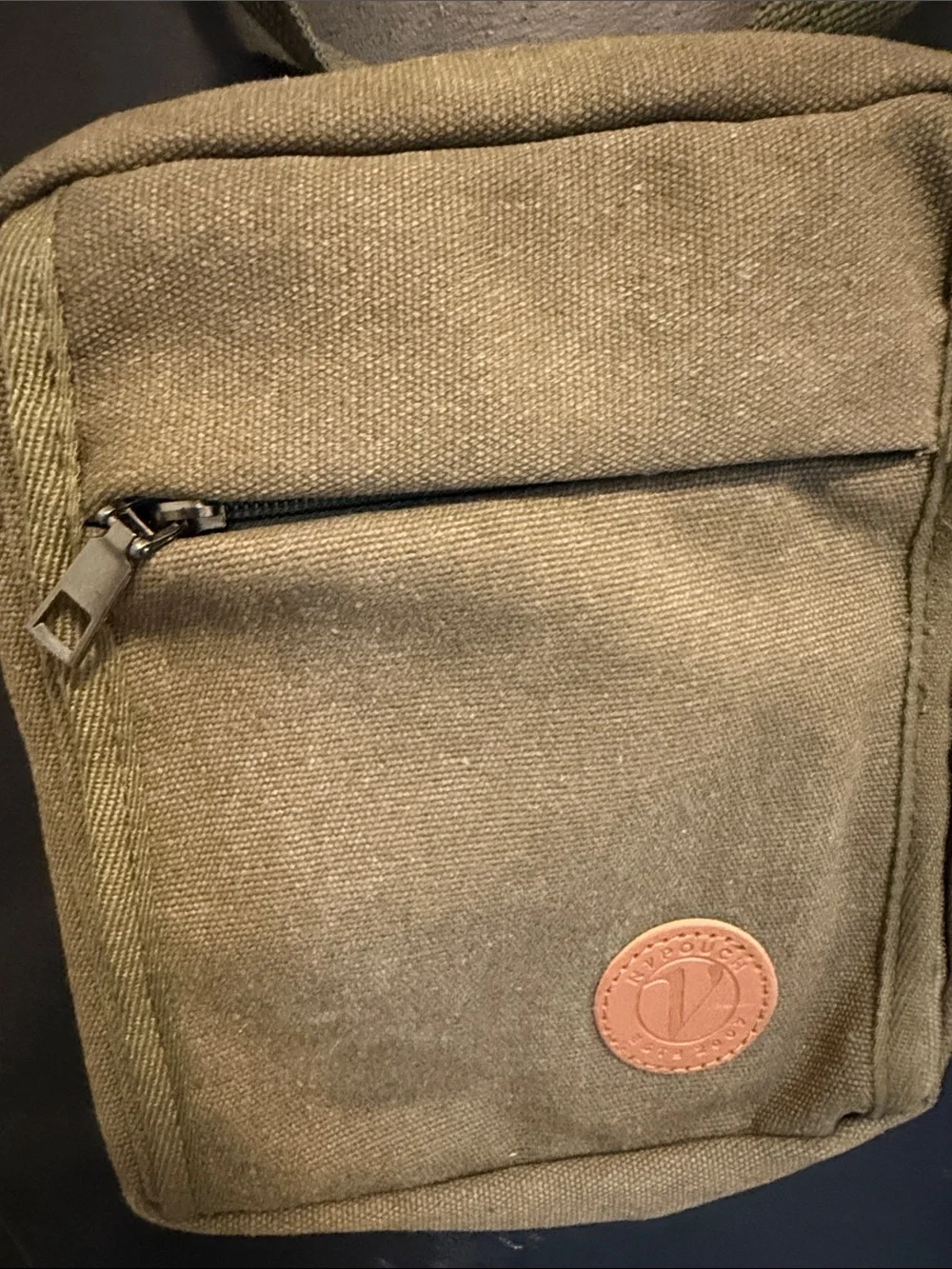 Unisex crossbody Nupouch crossbody bag. Olive colored with tan accent patch.